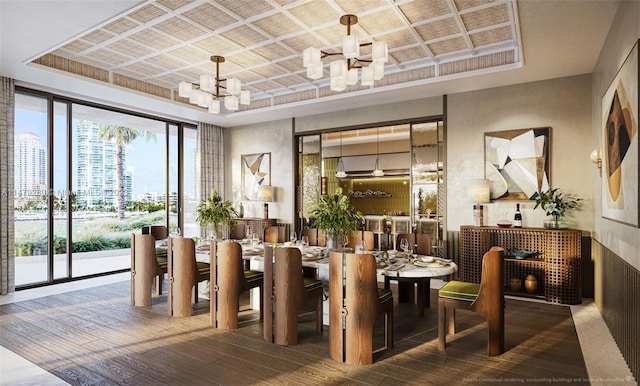 dining space with a raised ceiling, a notable chandelier, and dark hardwood / wood-style flooring