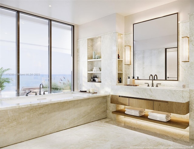 bathroom featuring a bath to relax in, tile flooring, and tile walls