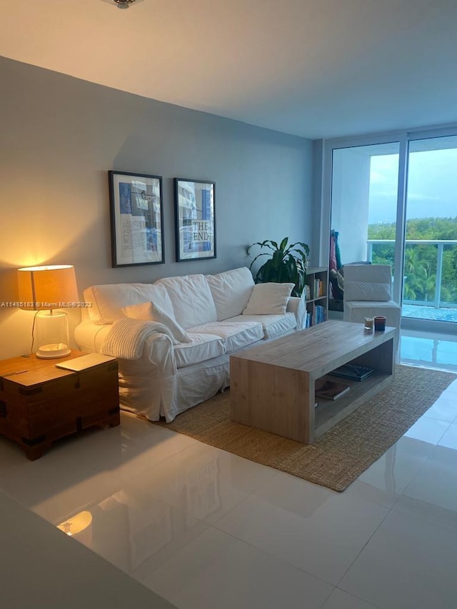 tiled living room with floor to ceiling windows