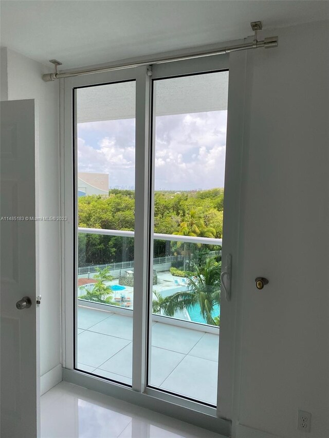 doorway featuring light tile floors