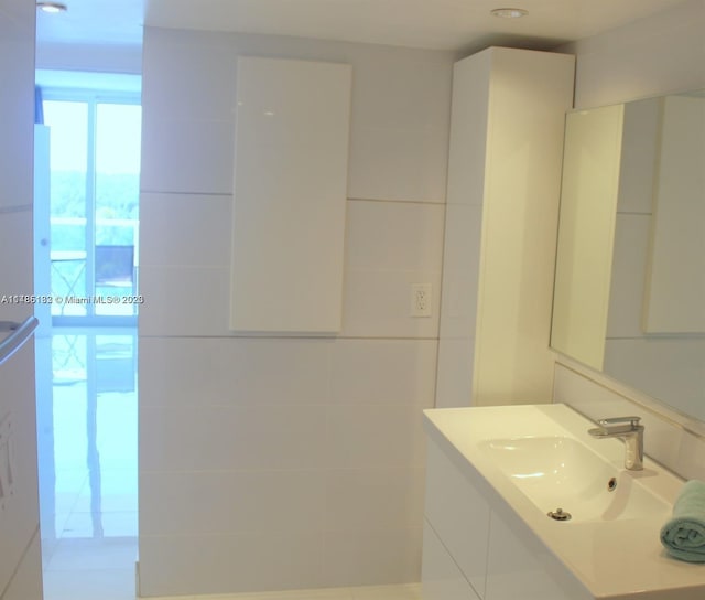 bathroom with tile walls and vanity