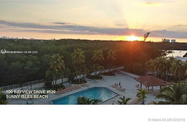 view of pool at dusk