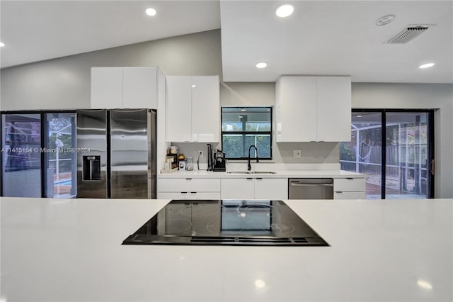 kitchen with sink, stainless steel appliances, and white cabinetry