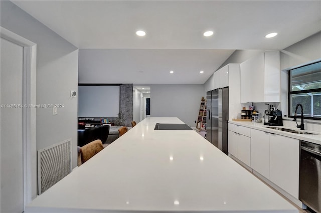 kitchen with dishwasher, sink, electric cooktop, stainless steel fridge with ice dispenser, and white cabinets