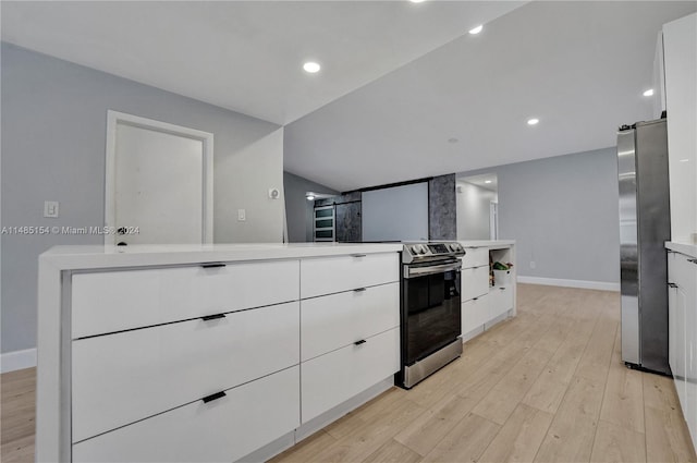 kitchen with stainless steel appliances, light hardwood / wood-style floors, and white cabinets