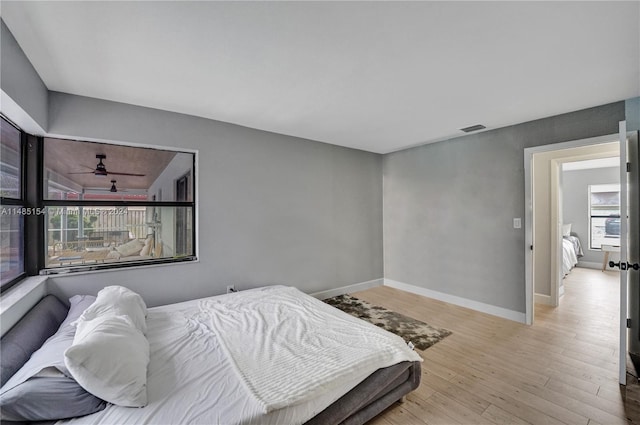 bedroom featuring light hardwood / wood-style floors and multiple windows