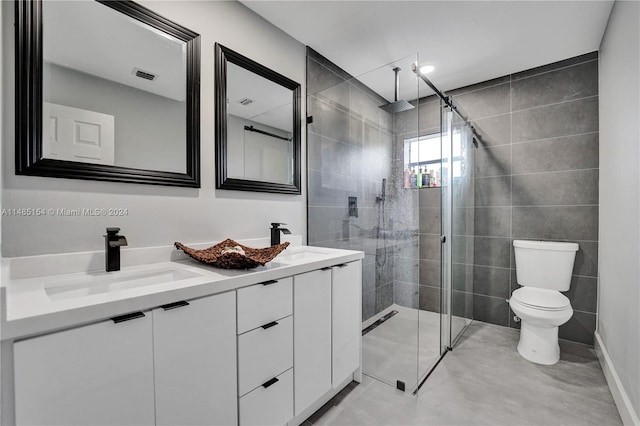 bathroom featuring an enclosed shower, tile walls, tile flooring, toilet, and double vanity