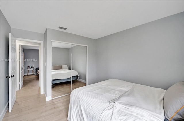 bedroom with a closet and light wood-type flooring