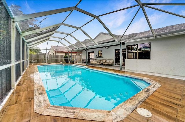 view of pool featuring a patio, ceiling fan, and a lanai