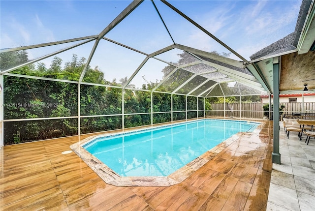 view of swimming pool with a lanai and a patio area