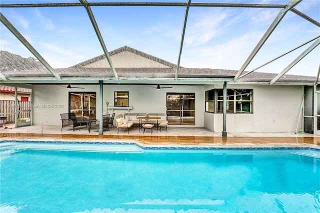 view of pool with a lanai, ceiling fan, and a patio