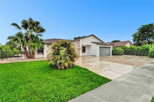 view of front of house featuring a front yard and a garage