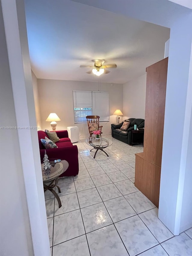 living room with ceiling fan and light tile patterned floors