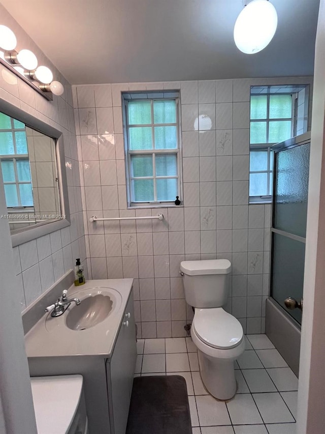 full bathroom featuring tile walls, a wealth of natural light, and tile patterned floors