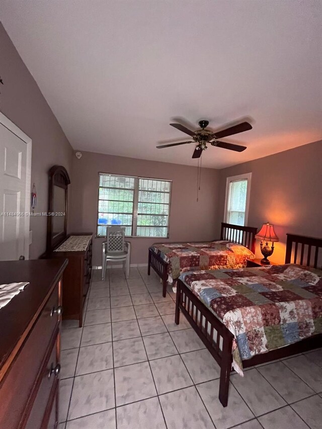 bedroom featuring light tile patterned flooring and ceiling fan