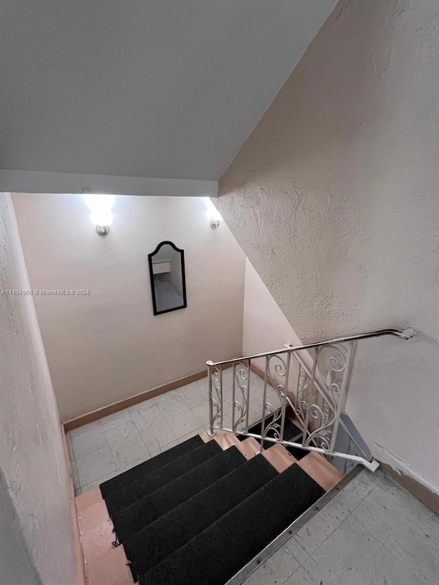 stairway with vaulted ceiling