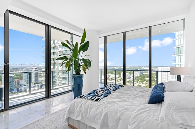 tiled bedroom with a wall of windows and access to exterior