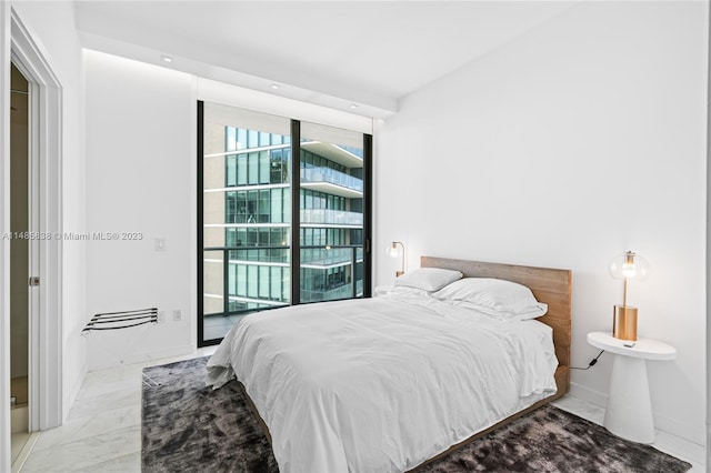 bedroom featuring access to exterior and light tile floors