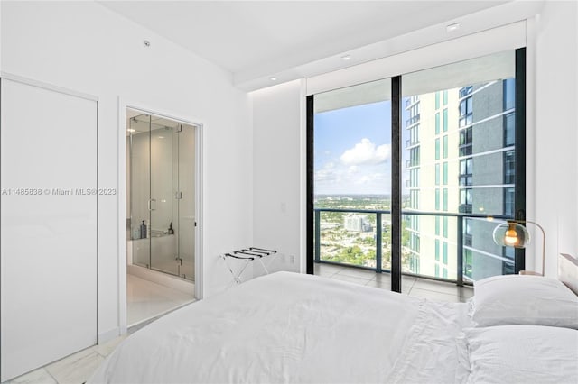 bedroom with light tile floors and connected bathroom