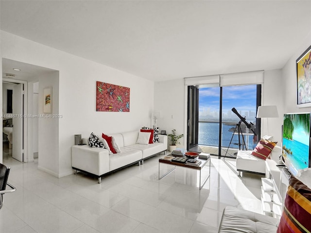 tiled living room with a water view