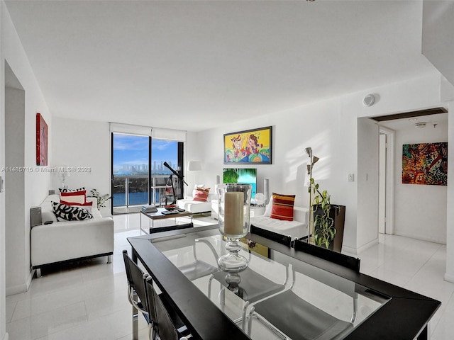 dining space featuring floor to ceiling windows, a water view, and light tile patterned floors