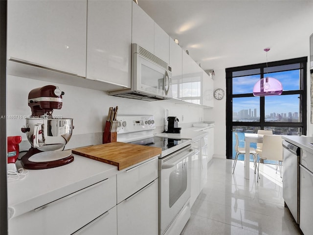 kitchen with white cabinetry, white appliances, and decorative light fixtures