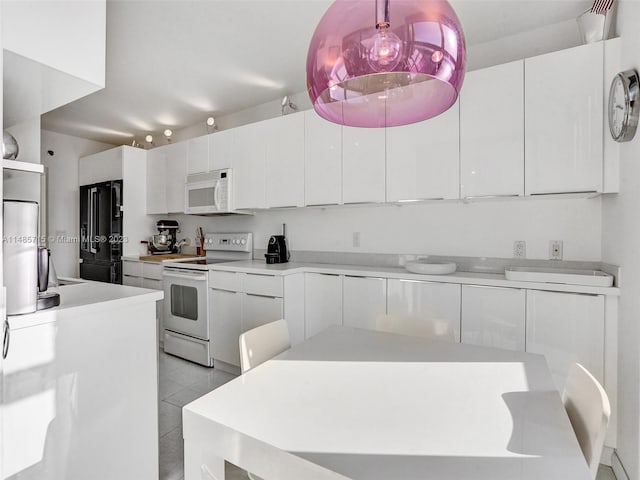 kitchen featuring white cabinetry, white appliances, and light tile patterned floors