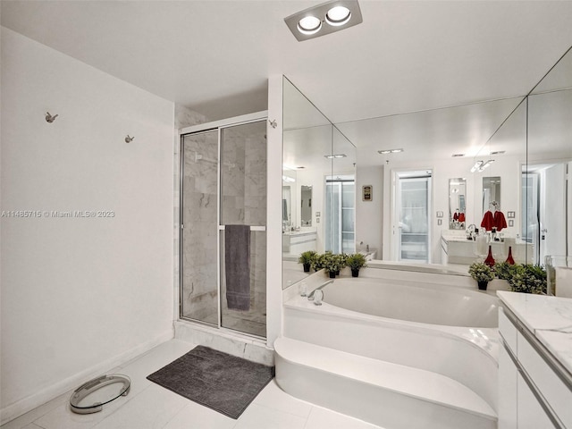 bathroom featuring vanity, shower with separate bathtub, and tile patterned flooring