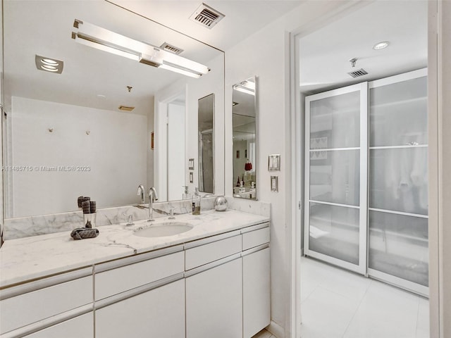 bathroom with vanity and tile patterned flooring