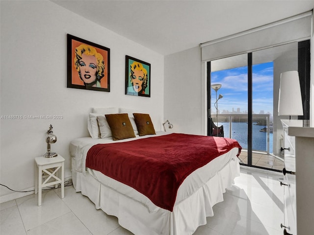 tiled bedroom with floor to ceiling windows, a water view, and access to exterior