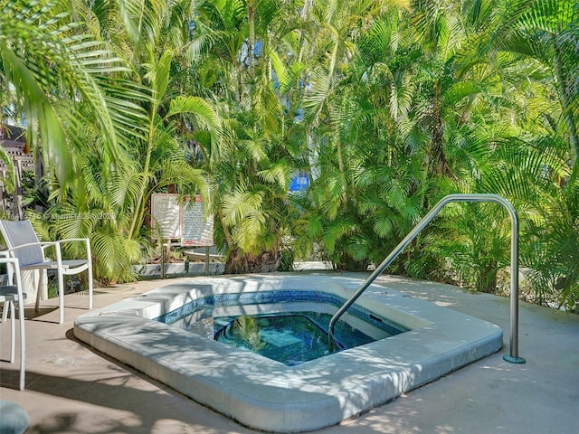 view of pool featuring a patio area and an in ground hot tub