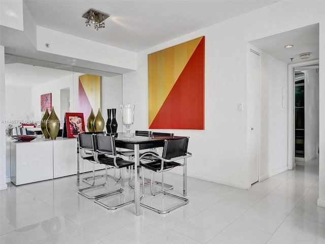 dining space featuring light tile patterned flooring