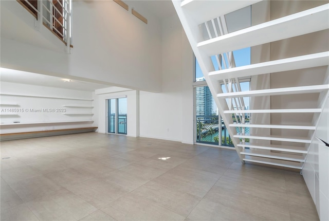 unfurnished room featuring a towering ceiling