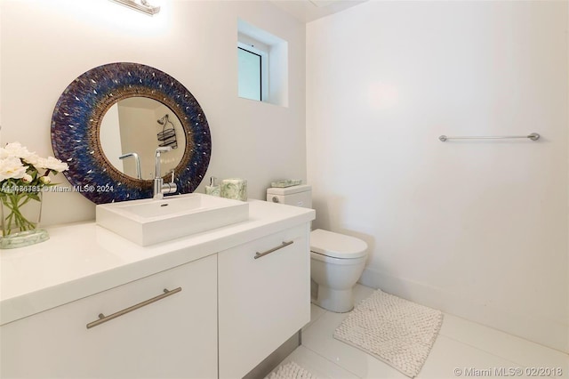 bathroom featuring tile floors, toilet, and vanity