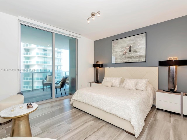 bedroom featuring light hardwood / wood-style floors and access to exterior