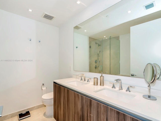 bathroom featuring vanity, toilet, tile patterned floors, and a shower with door