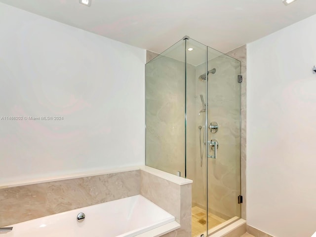 bathroom with separate shower and tub