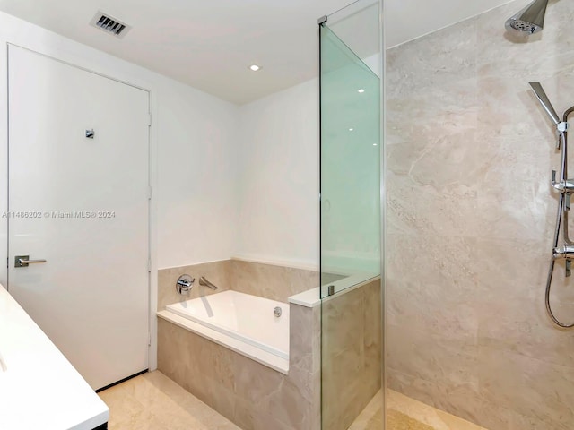 bathroom with independent shower and bath, vanity, and tile patterned floors