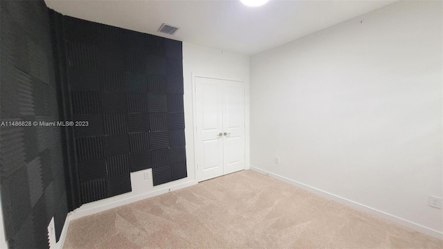 empty room with light colored carpet