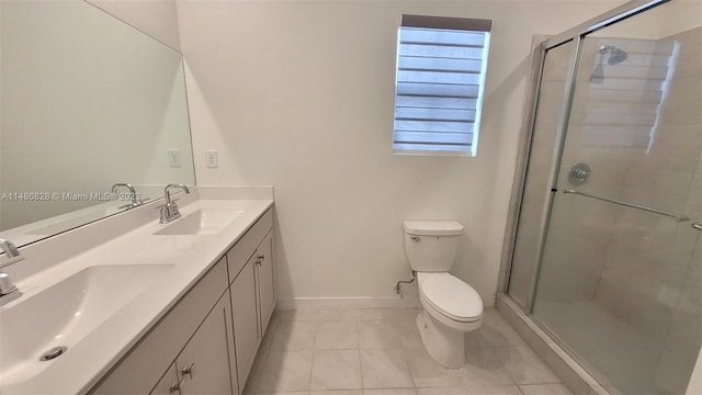 bathroom featuring a shower with door, tile floors, double vanity, and toilet