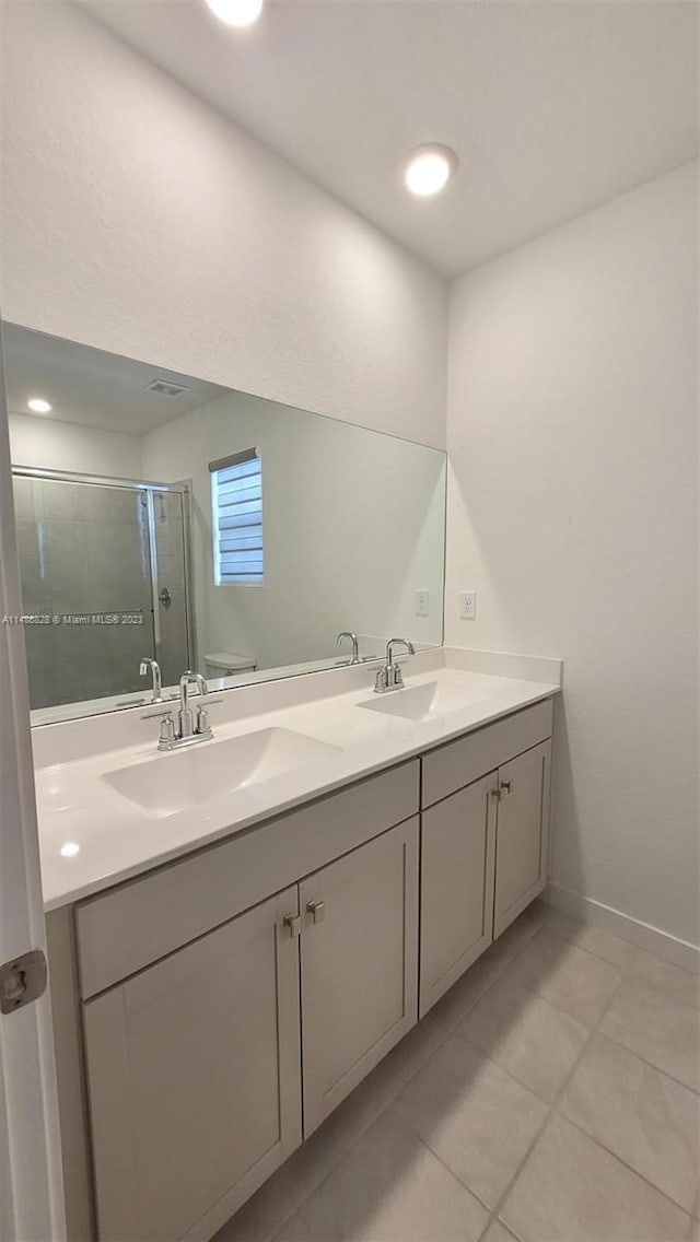 bathroom featuring double sink vanity and tile floors