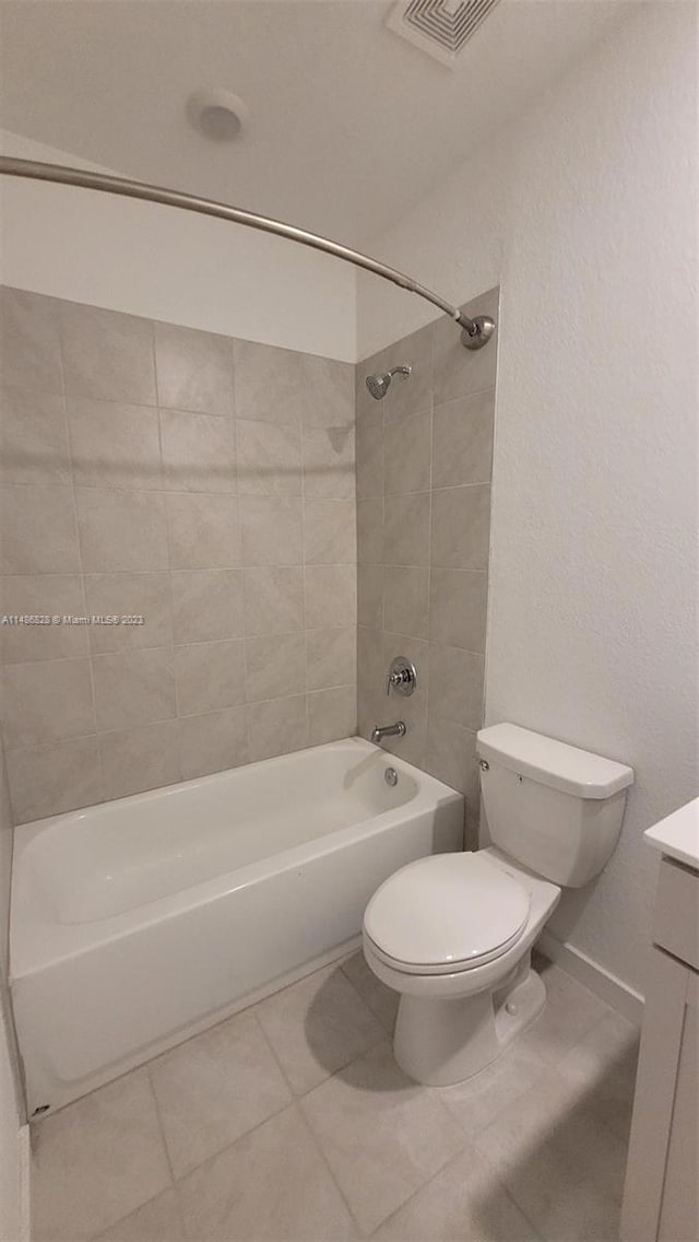 full bathroom featuring toilet, vanity, tiled shower / bath, and tile flooring