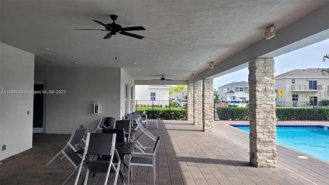 view of patio with ceiling fan and a fenced in pool