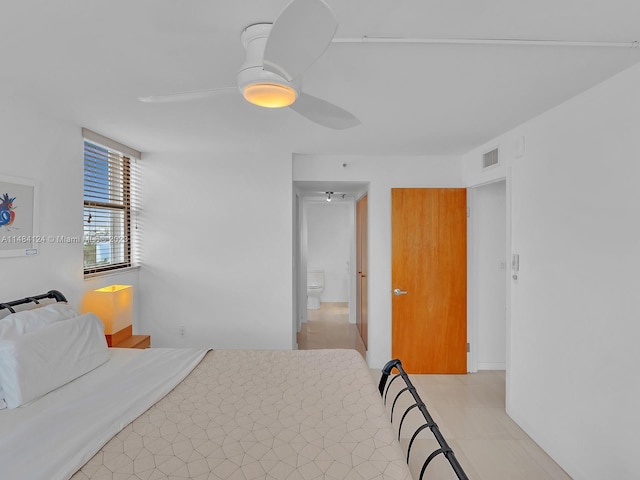 bedroom featuring ensuite bath and ceiling fan