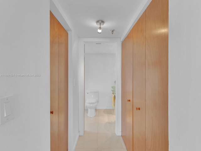 corridor with light tile patterned floors