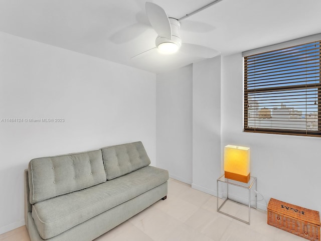 sitting room featuring ceiling fan