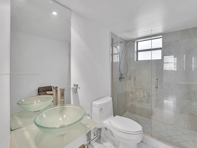 bathroom featuring walk in shower, vanity, and toilet