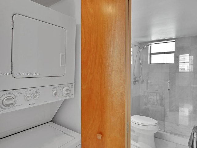 laundry area featuring stacked washer and dryer