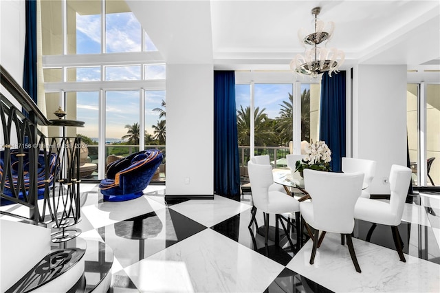 tiled dining room with a notable chandelier and a tray ceiling