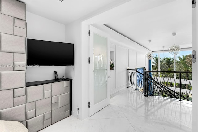 interior space featuring light tile flooring and a notable chandelier